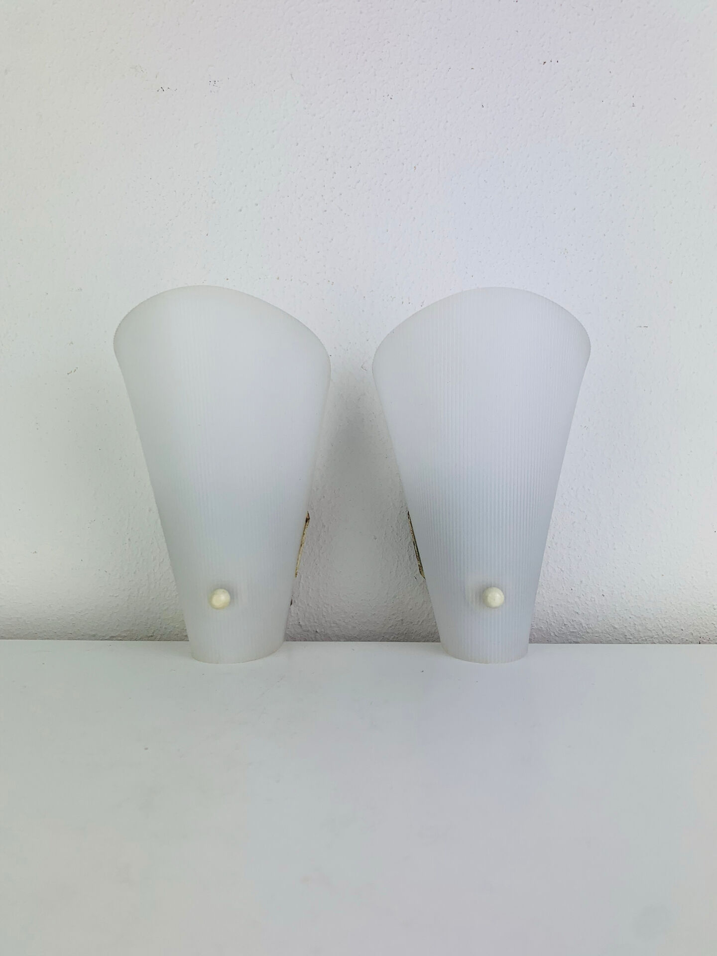 Pair of 1950s striped plastic wall lights.