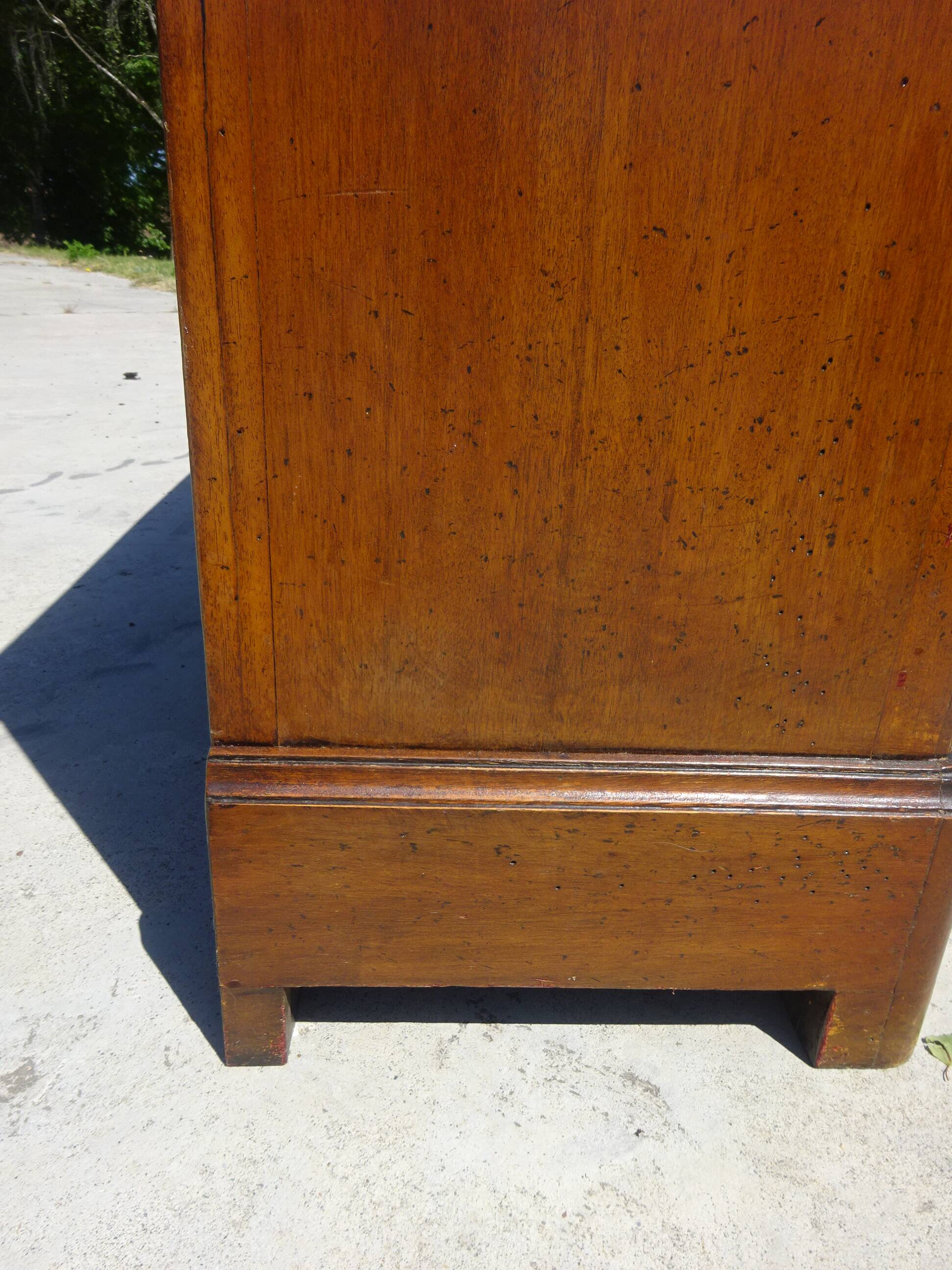 Chest of drawers with decorated handles in the Louis XVI style.