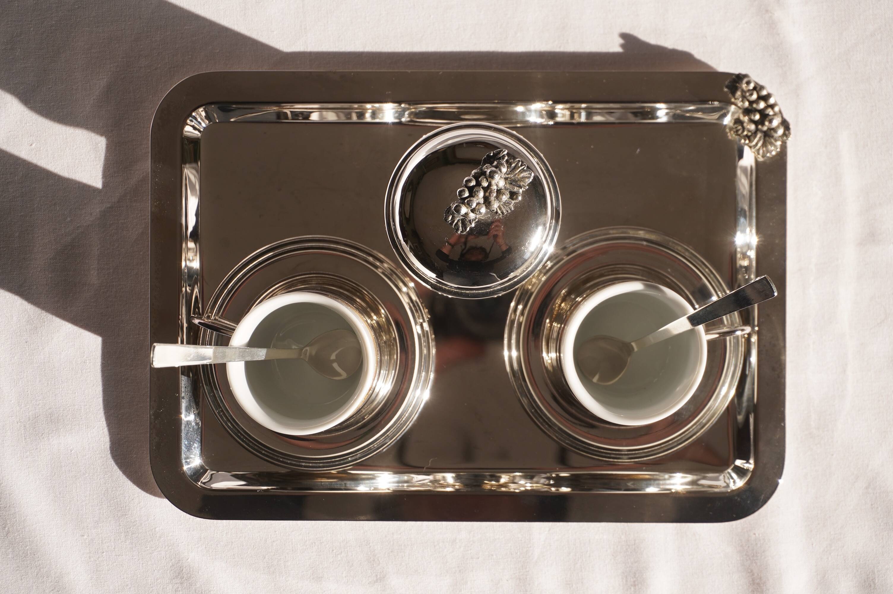 Silver-plated metal coffee service with a grape design.