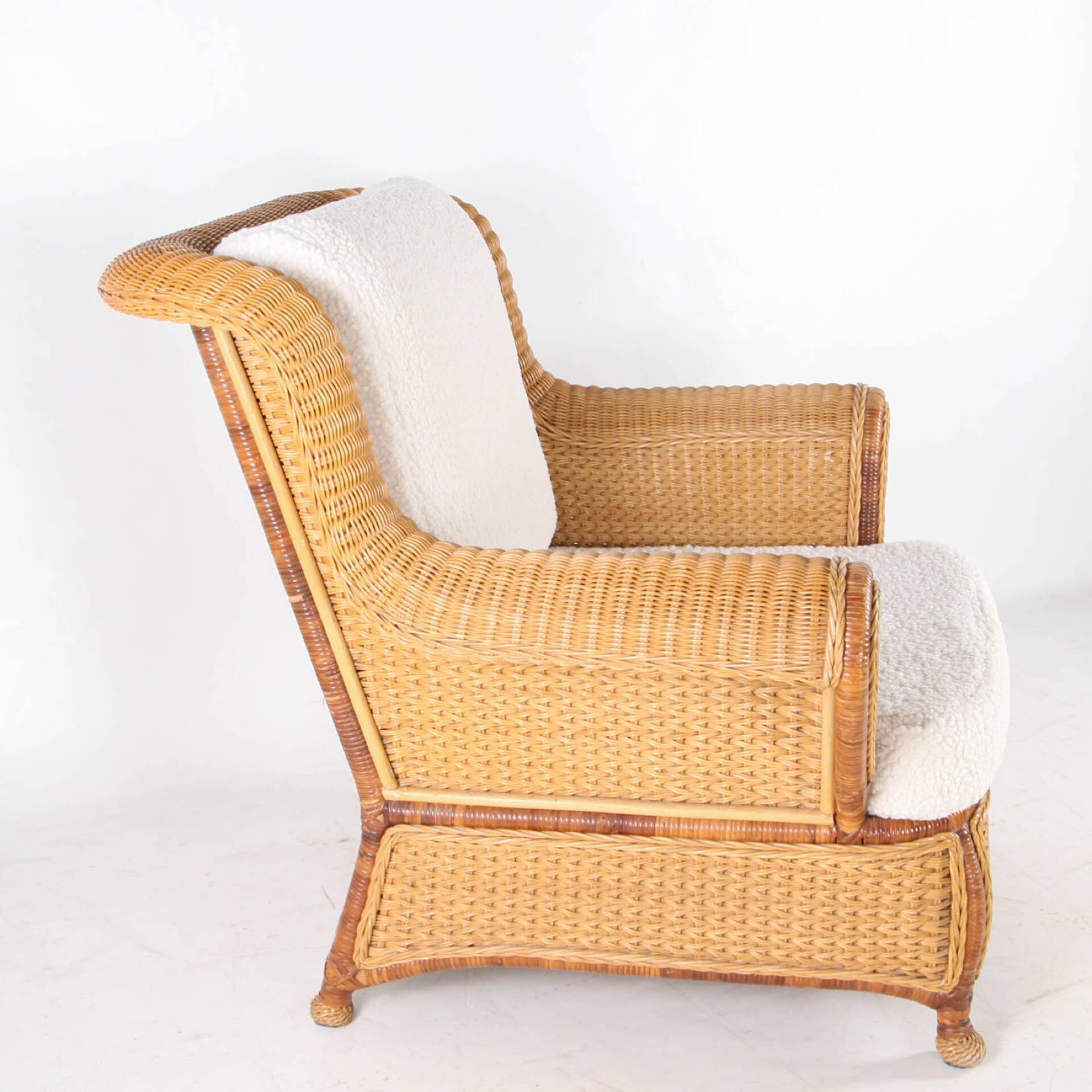 Large wicker armchair and its ottoman