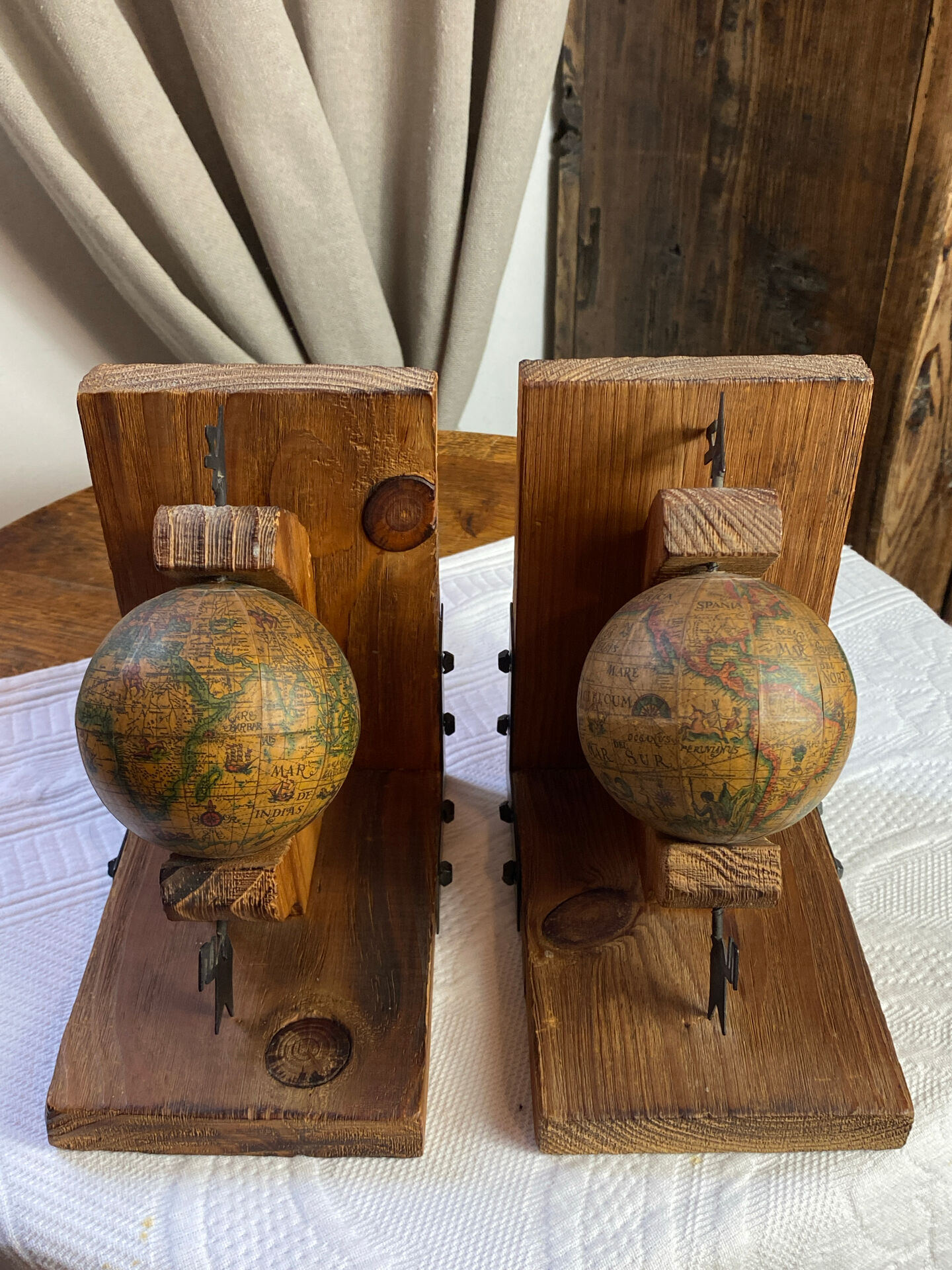 Pair of wooden bookends, rotating globes