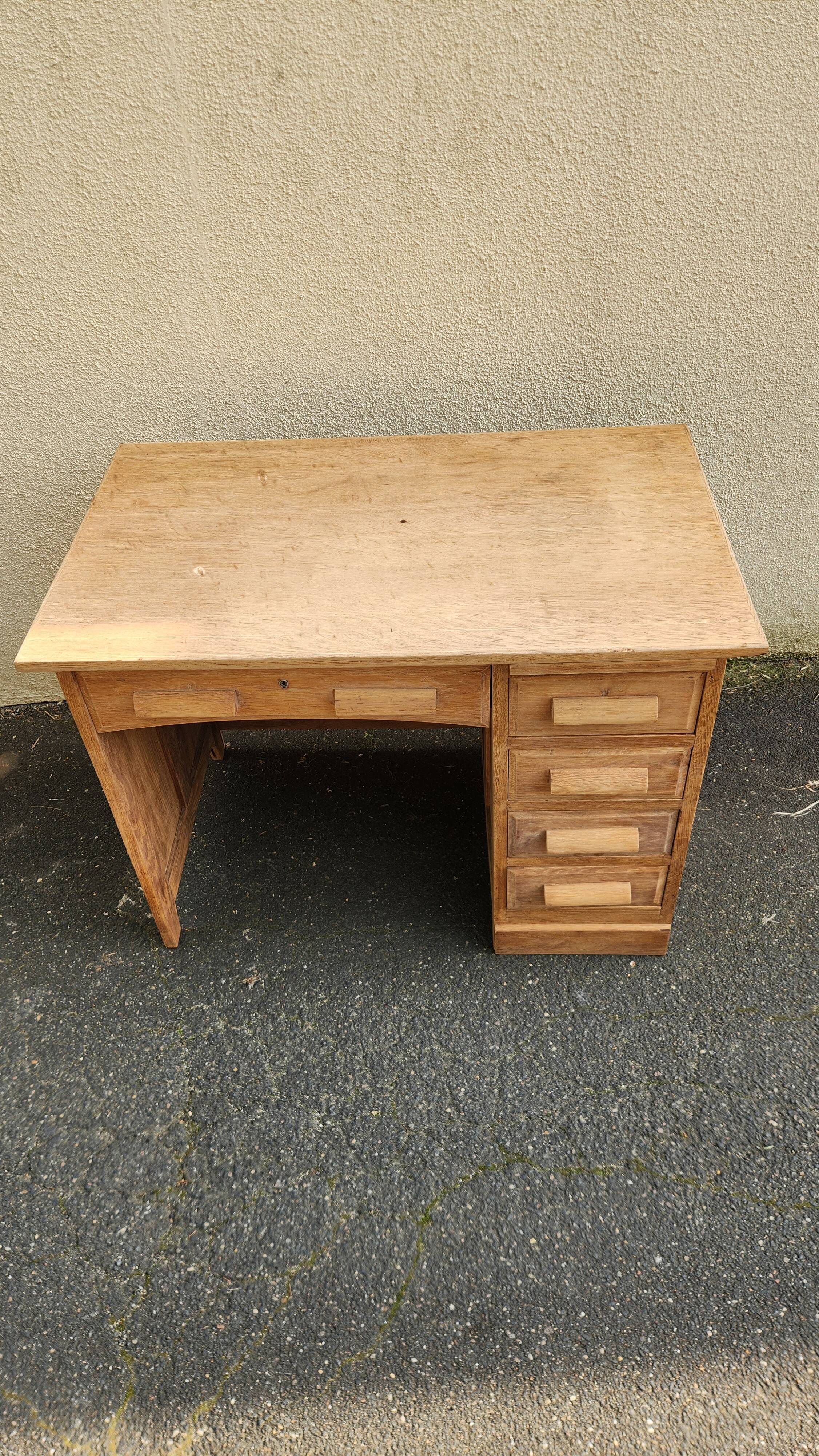 Vintage wooden desk with five drawers from the 1950s-1970s.