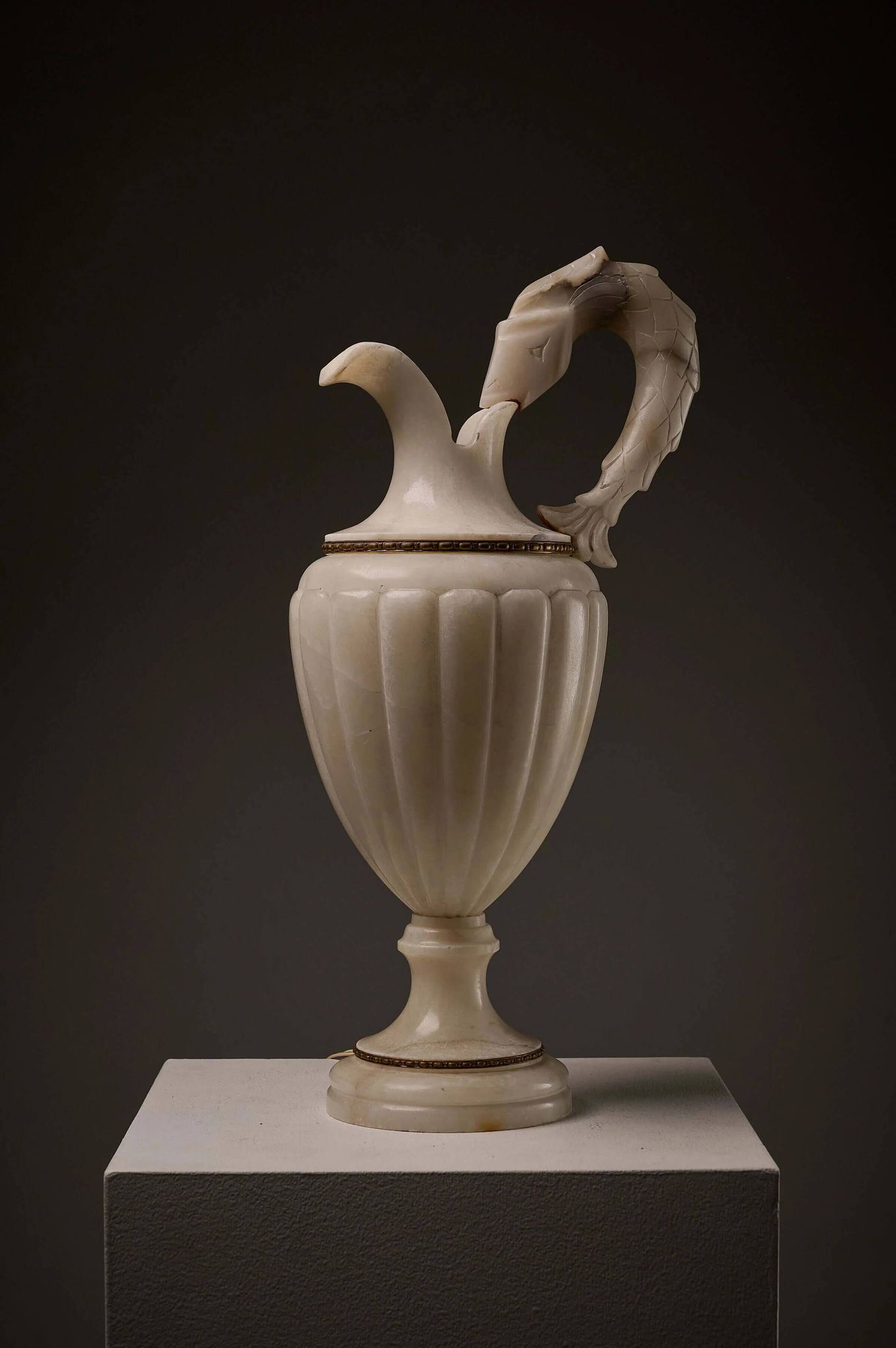 Carved alabaster urn lamp with stylized fish handle