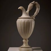 Carved alabaster urn lamp with stylized fish handle