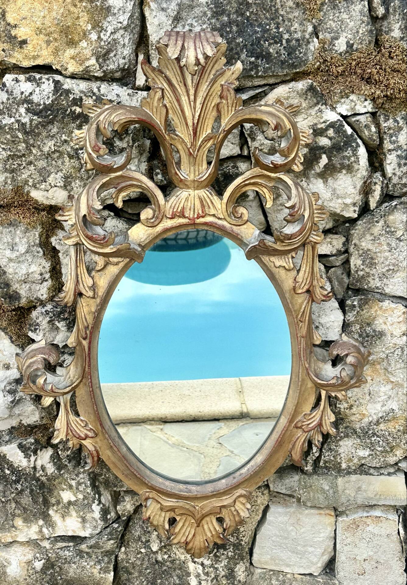 Miroir en bois doré sculpté .