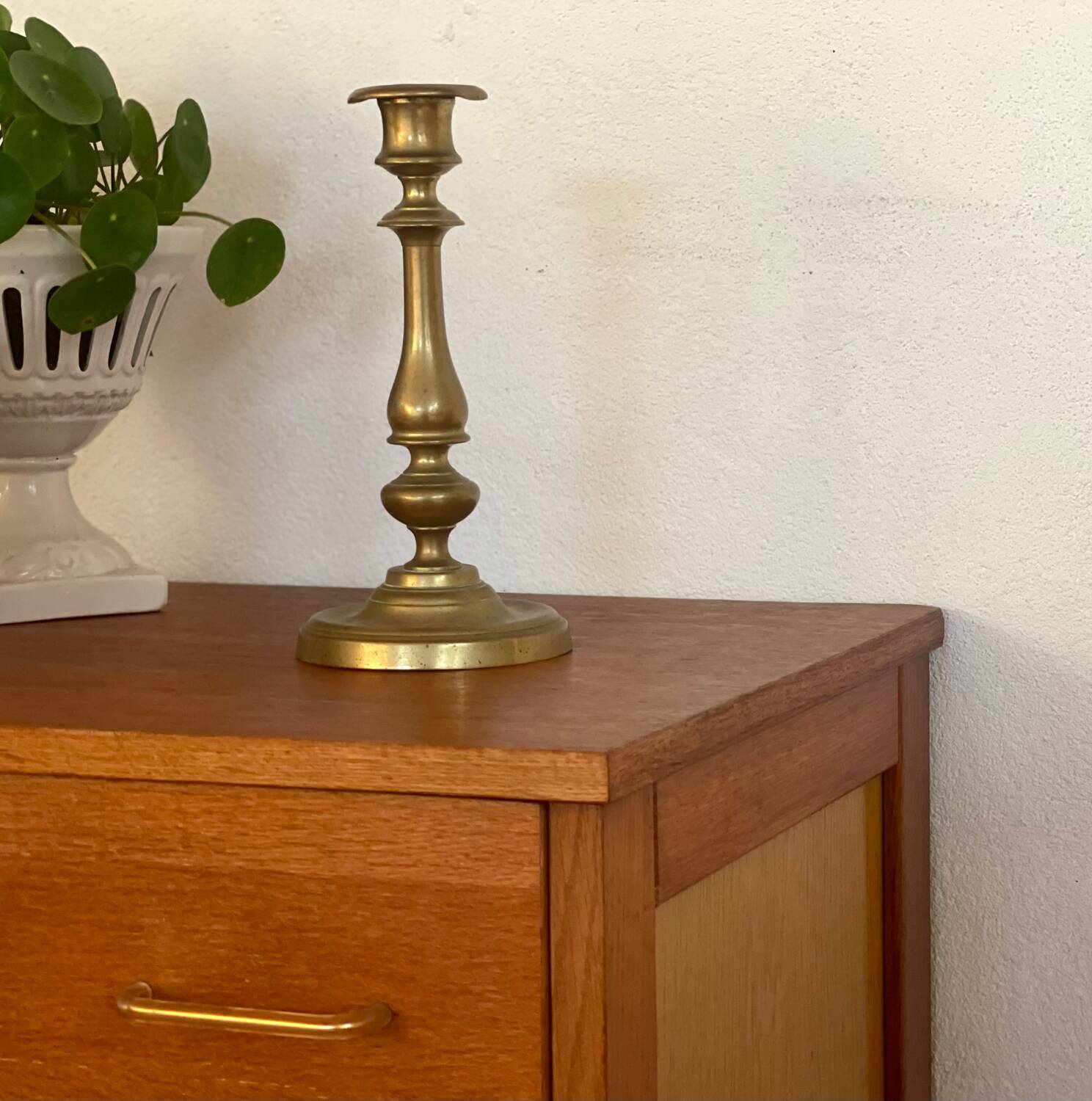 Vintage 1960s chest of drawers with covered handles.