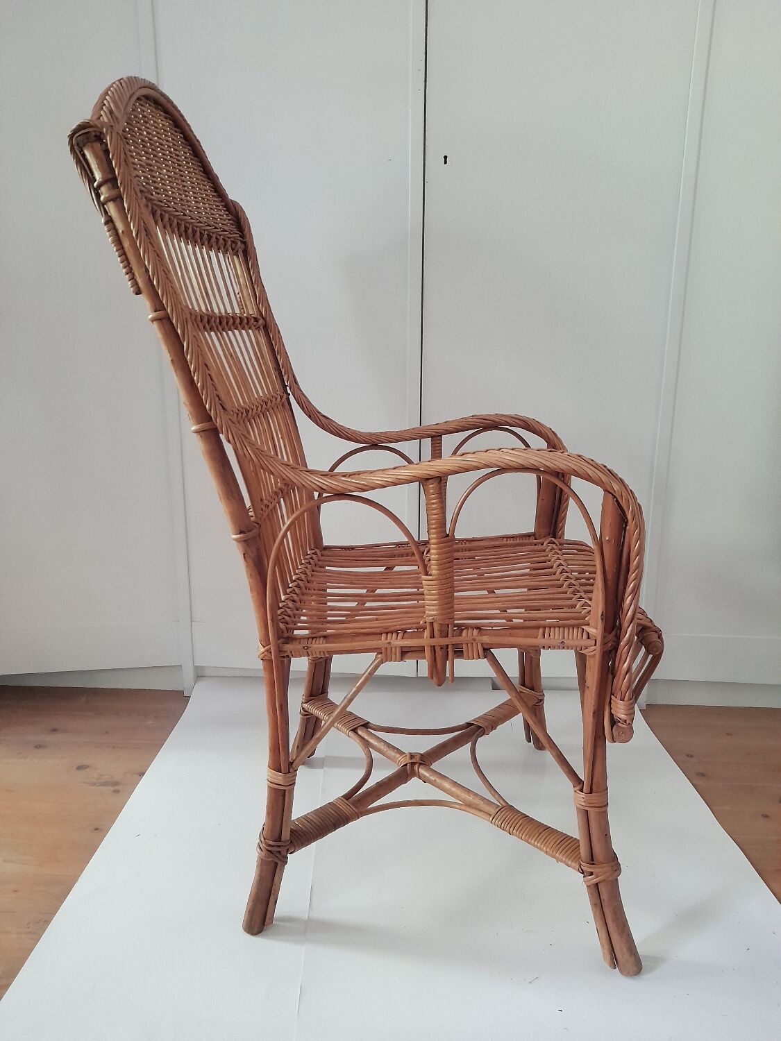 High-backed wicker armchair