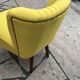 Yellow cocktail chair in solid beech, 1960s, with fluted backrest and tapered legs.