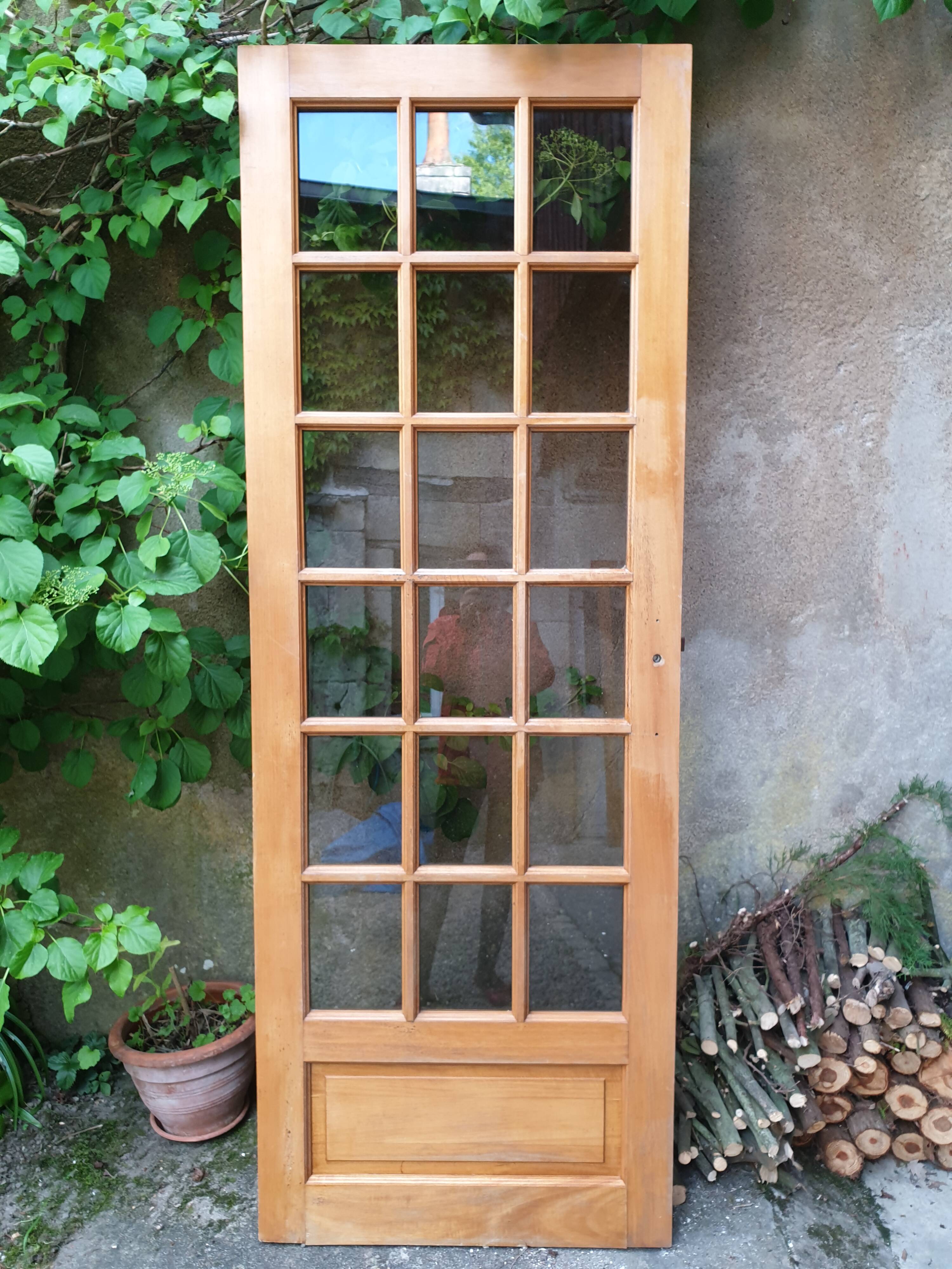 Old wooden door glazed with small tiles