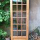 Old wooden door glazed with small tiles