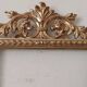 Mirror with a carved wooden frame in an antique style in pure gold.