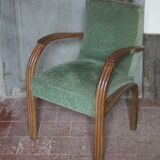 Art Deco armchair in wood and green fabric, living room armchair, interior decor.