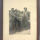 Fishing trophy with radiant faces, c. 1950. Black and white photograph.