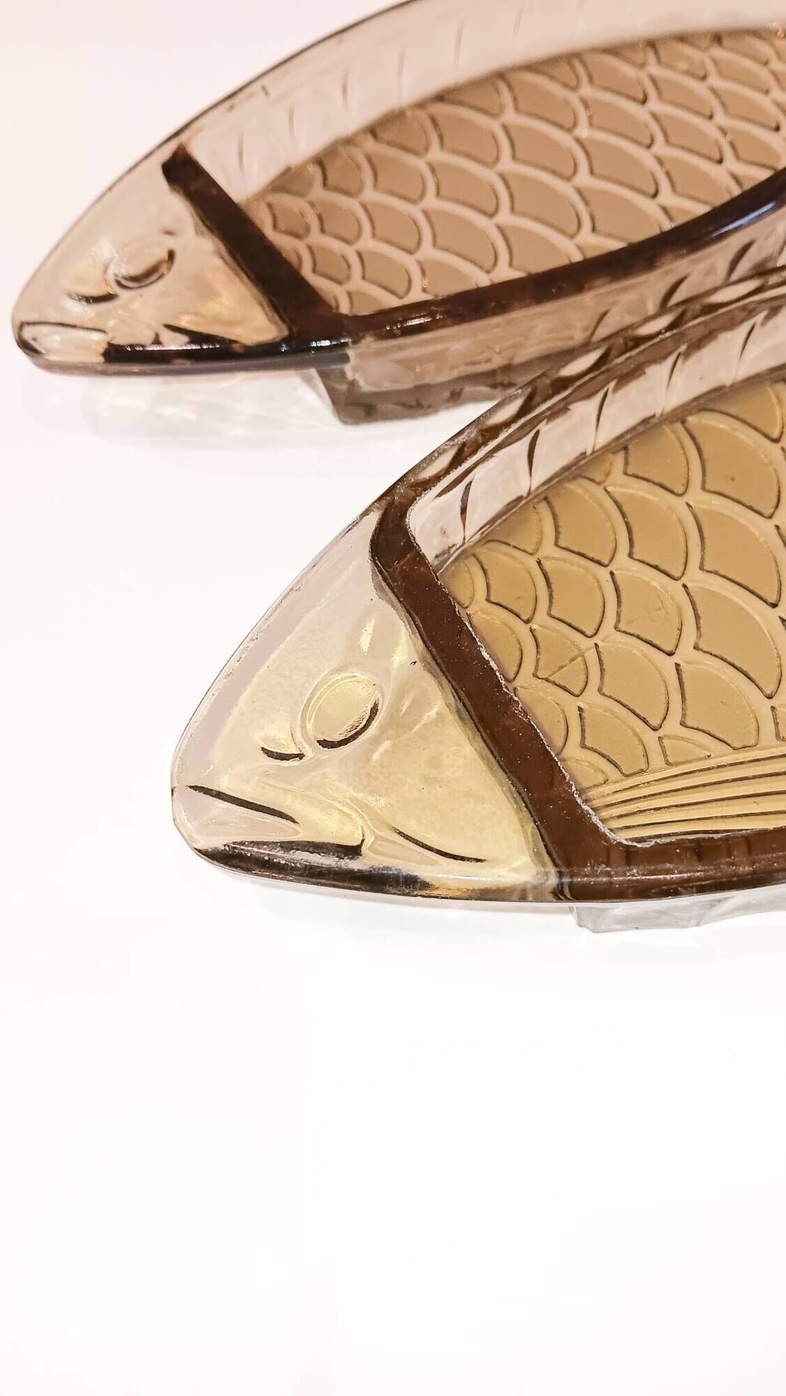 Set of 2 transparent smoked glass bowls in the shape of a fish.