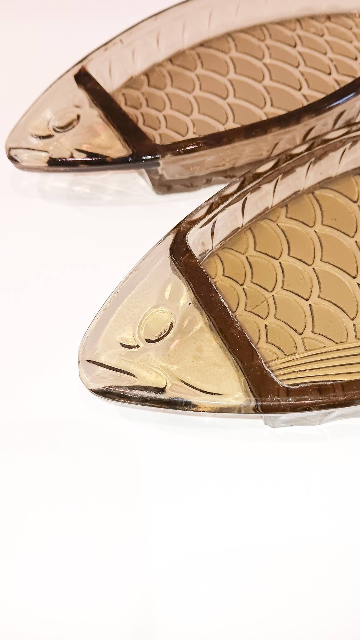 Set of 2 transparent smoked glass bowls in the shape of a fish.