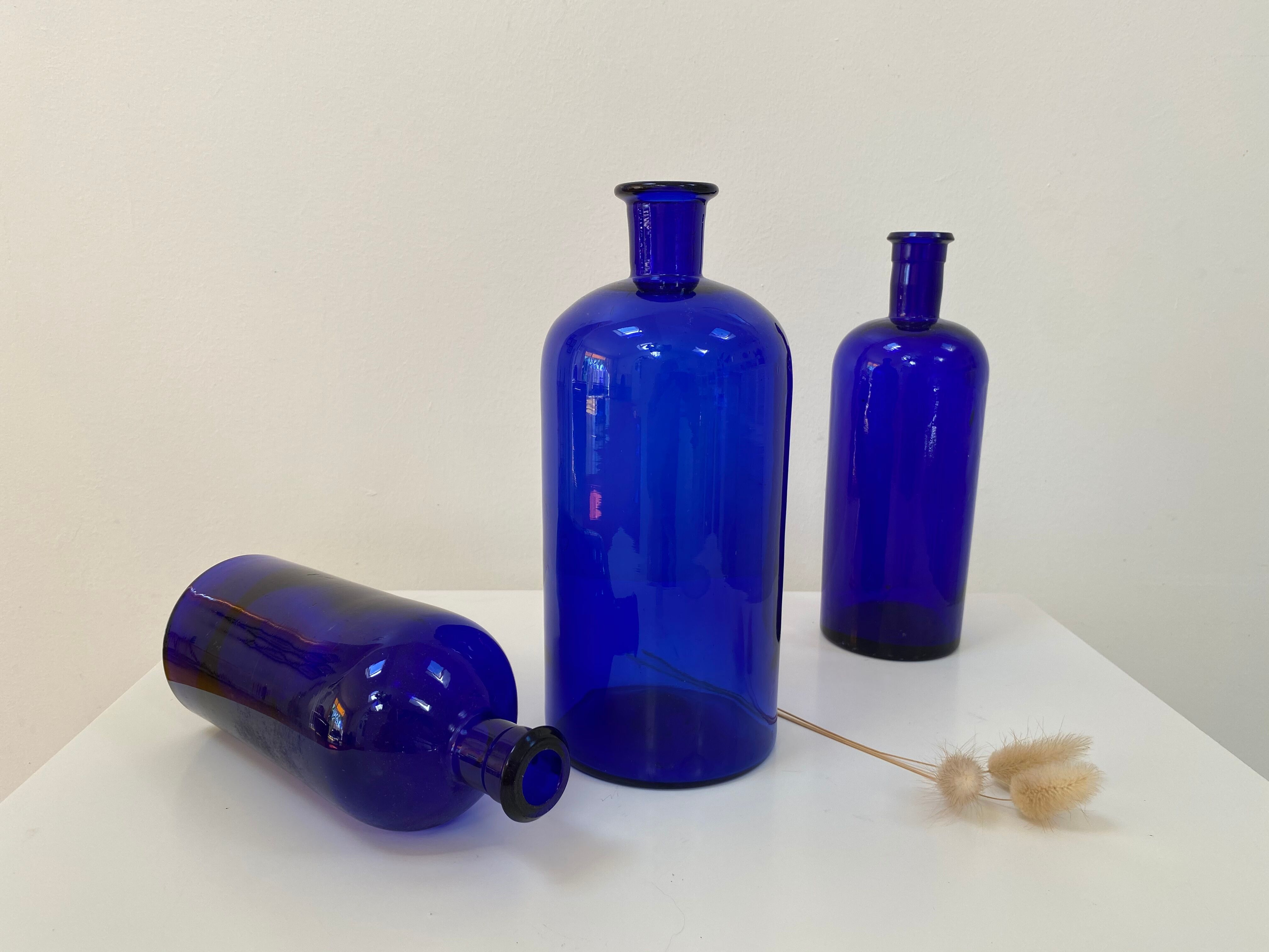 Trio of apothecary bottles in cobalt blue glass