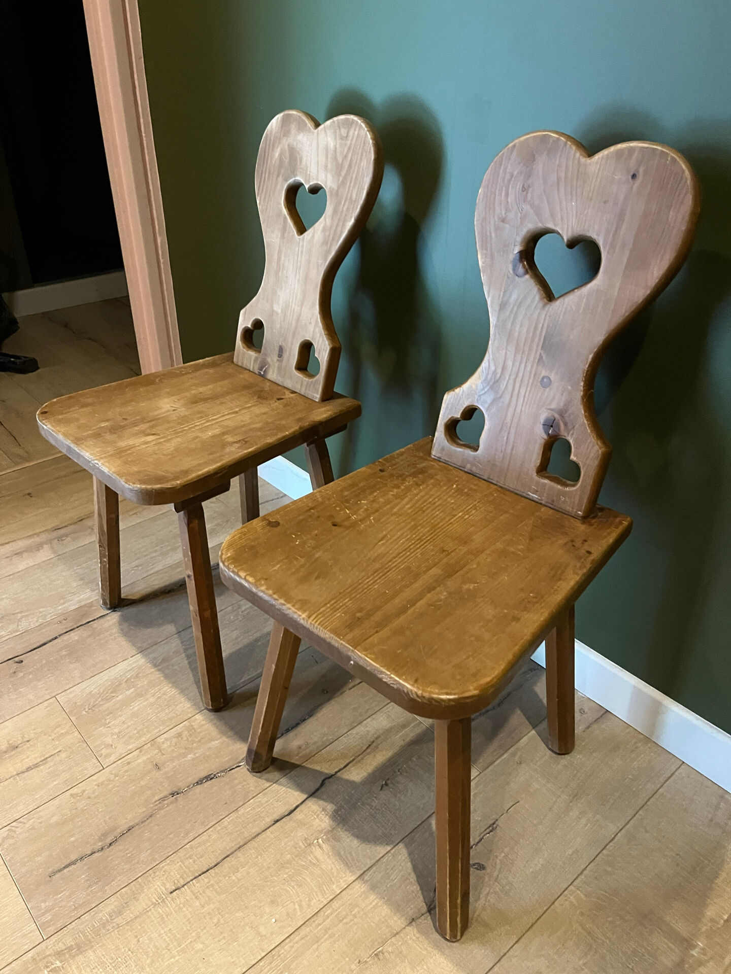 Pair of vintage wooden chairs in alpine chalet style.