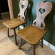 Pair of vintage wooden chairs in alpine chalet style.