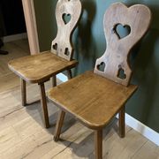 Pair of vintage wooden chairs in alpine chalet style.