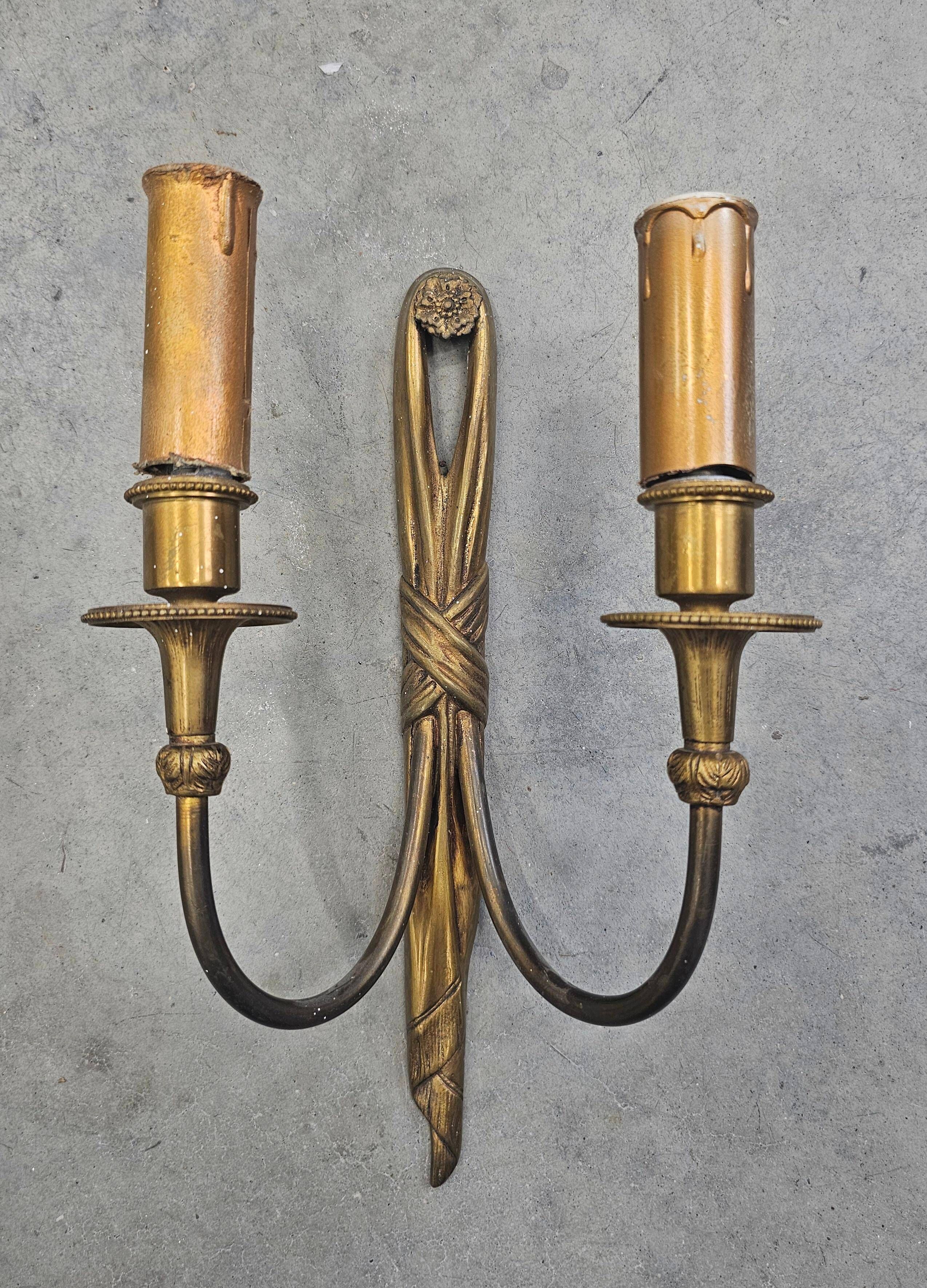 Pair of Louis XVI style bronze wall sconces with bow and tassel, 1940s.