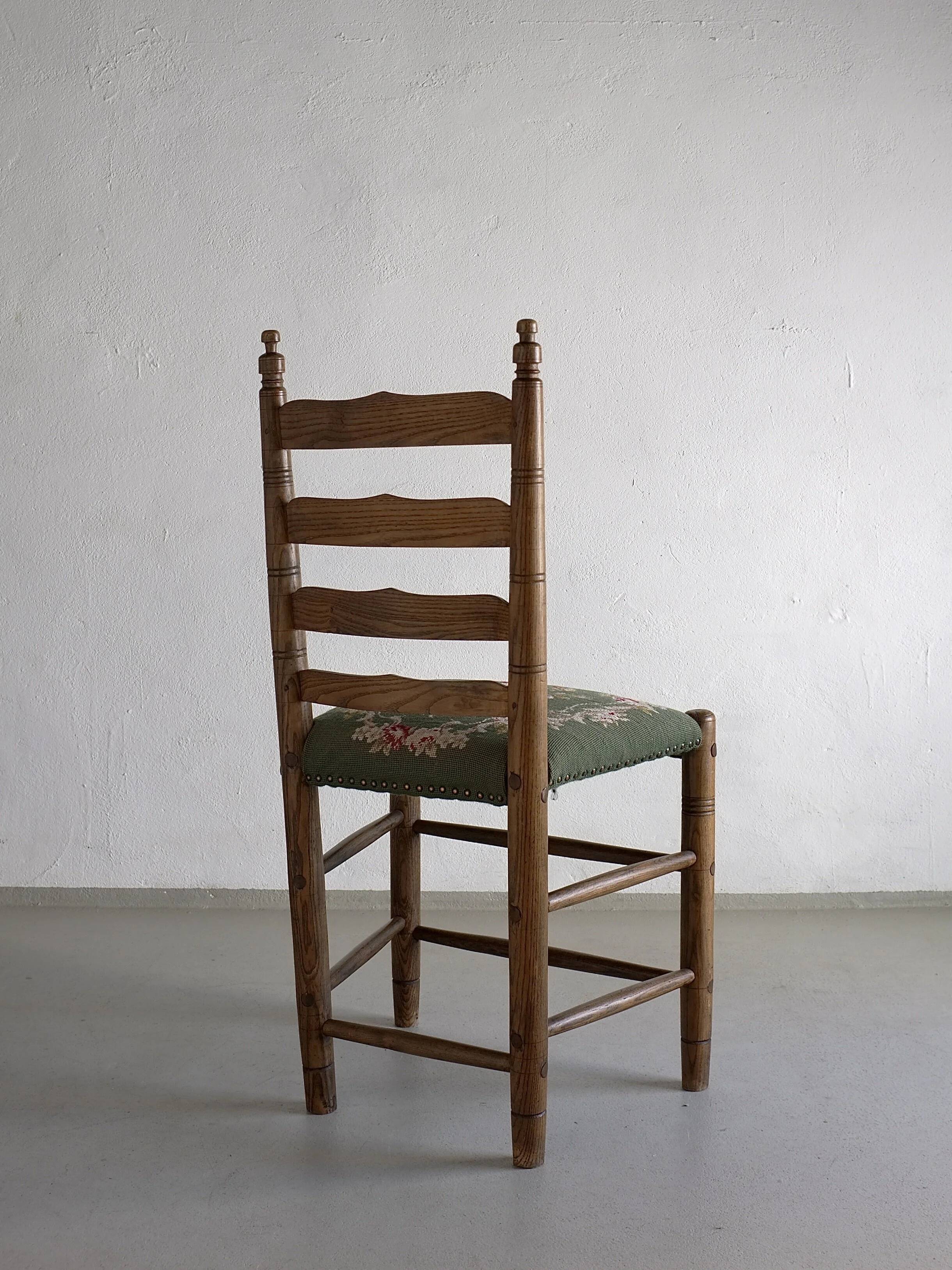 Rustic ladder-back oak chairs with embroidered seats | Netherlands | 1950s