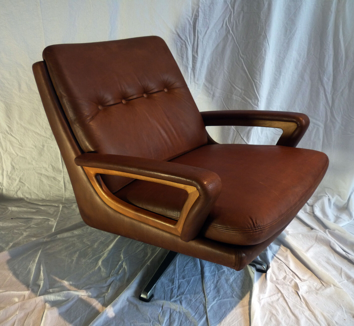 Leather and wood swivel armchair