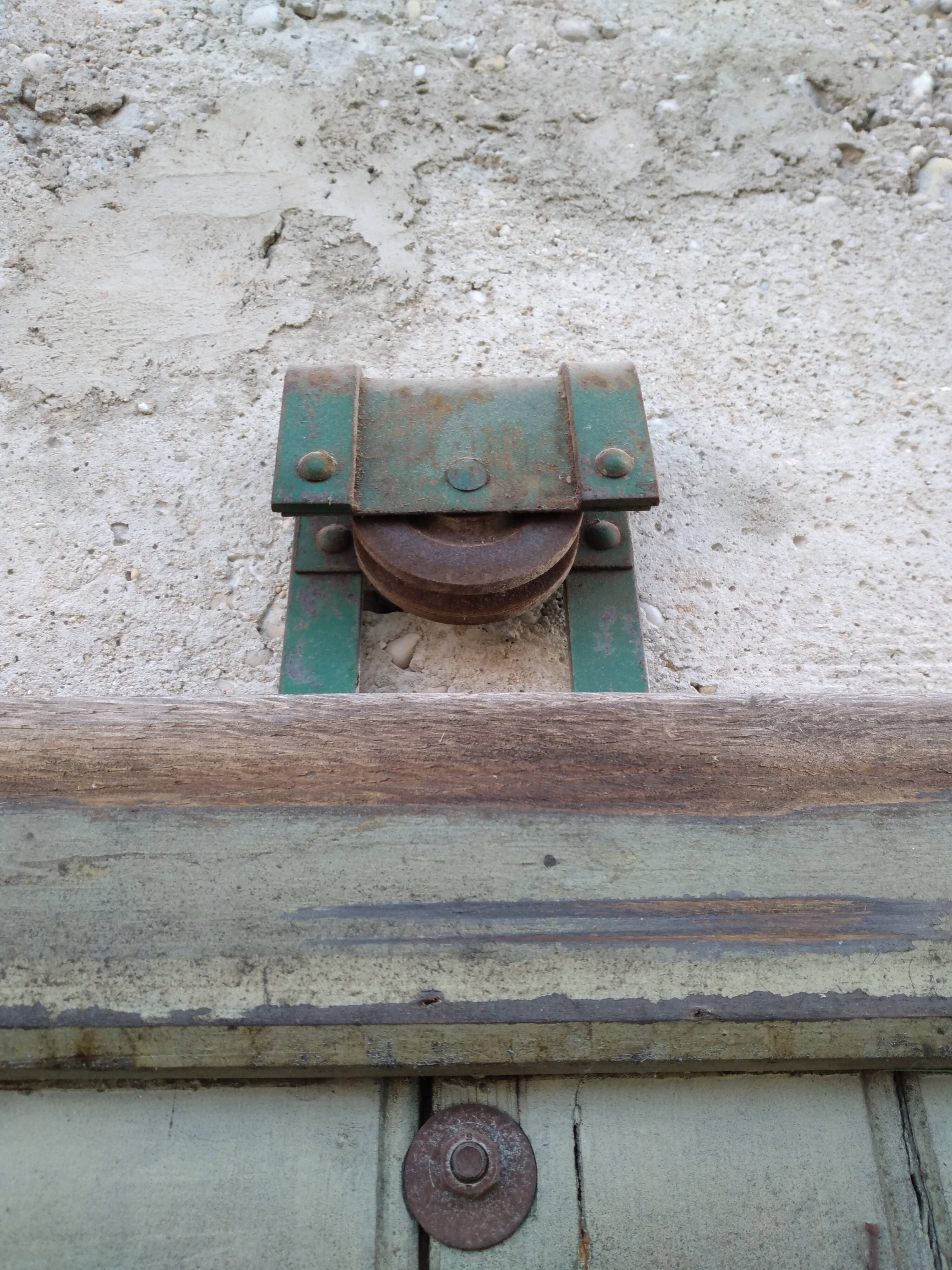 Old wooden door with pulley