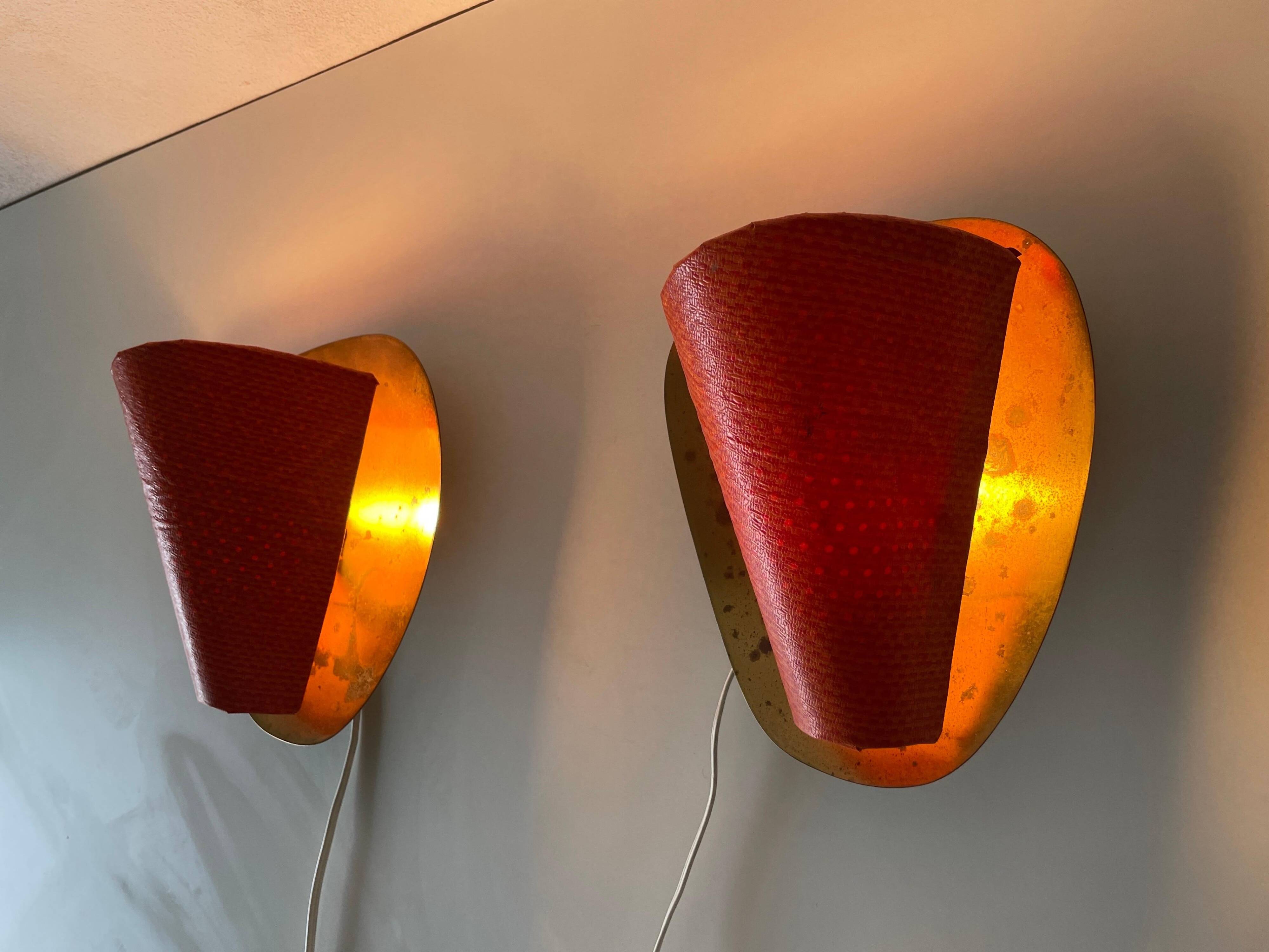 Pair of orange plexiglass and curved brass wall lights, 1950s, Germany