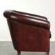 Vintage sheepskin club armchair with decorative nails and black piping