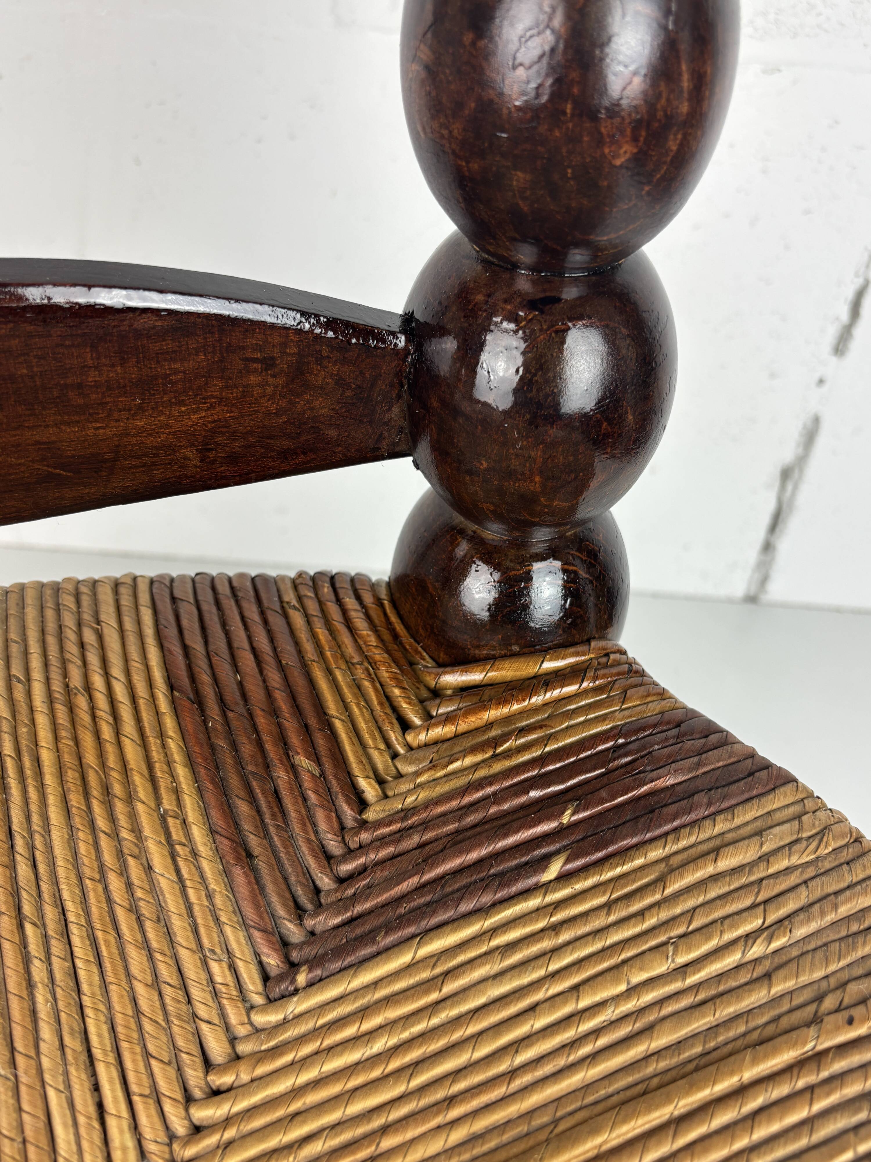 Brutalist wood turned bobbin low rush chair n the style of Charles Dudouyt