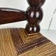 Brutalist wood turned bobbin low rush chair n the style of Charles Dudouyt