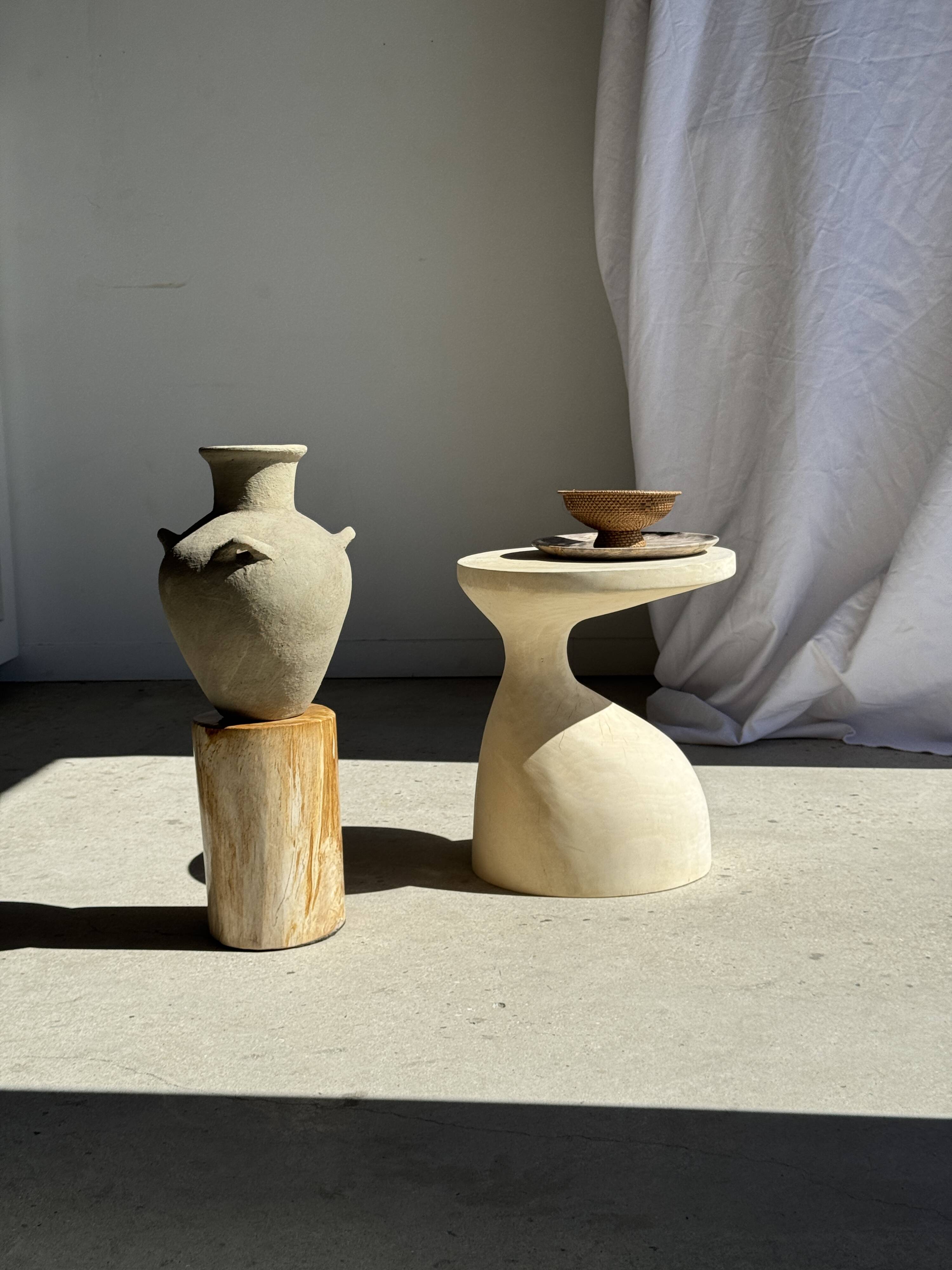 Light beige-grey Indonesian terracotta vase with 4 small handles and a high neck.