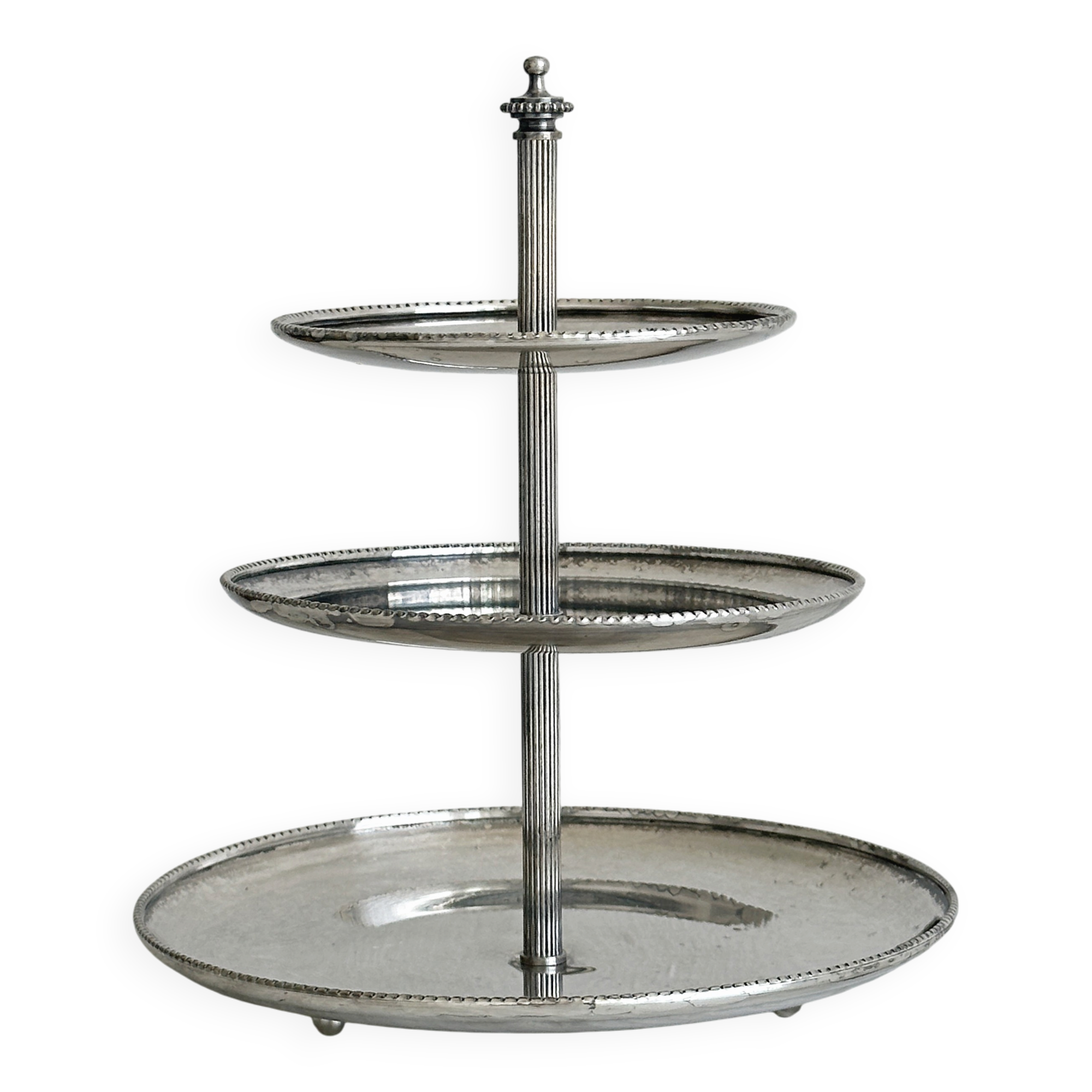 Vintage three-tiered serving stand in patinated silver metal.