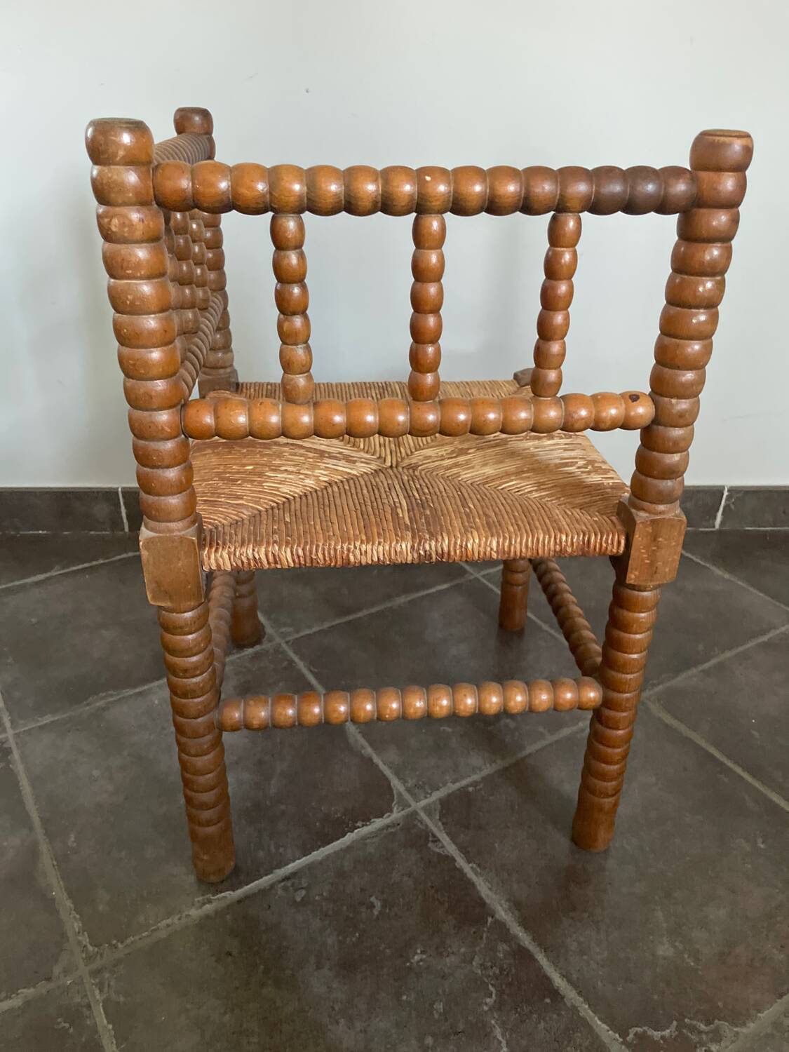 Old armchair, corner chair, made of wood and straw