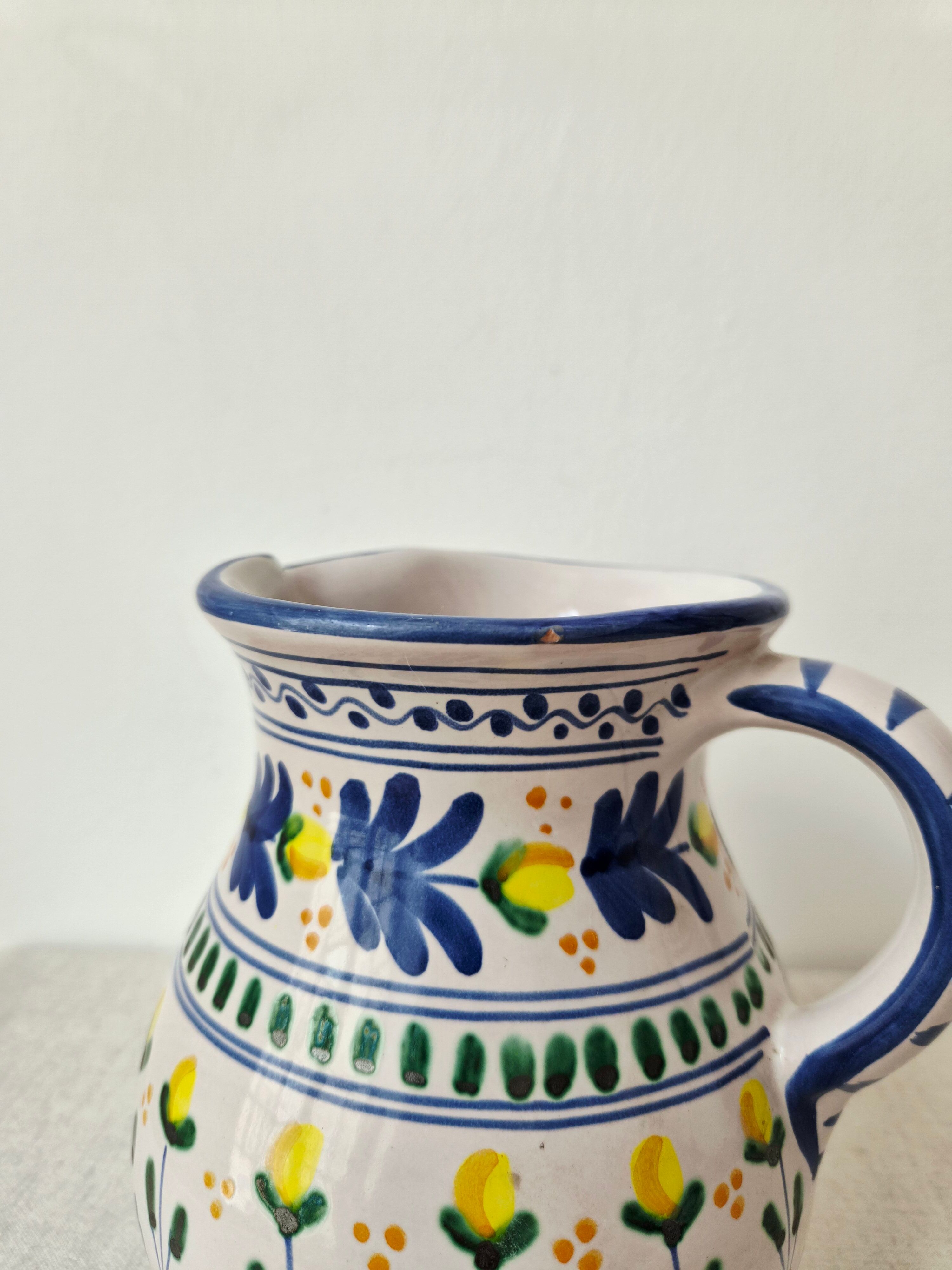Vintage ceramic pitcher/vase hand-painted with floral decoration.