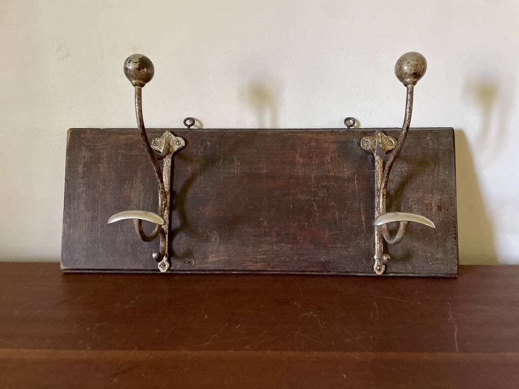Patinated wood and metal coat rack from the 1950s.