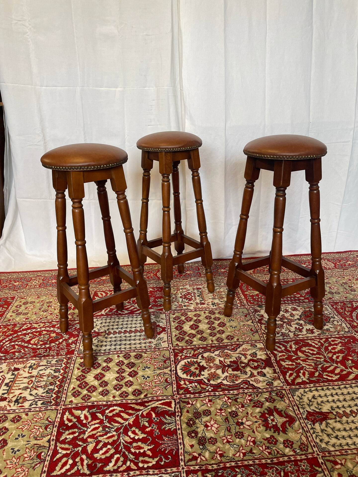 Set of 3 antique wooden and leather bar stools.