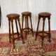 Set of 3 antique wooden and leather bar stools.