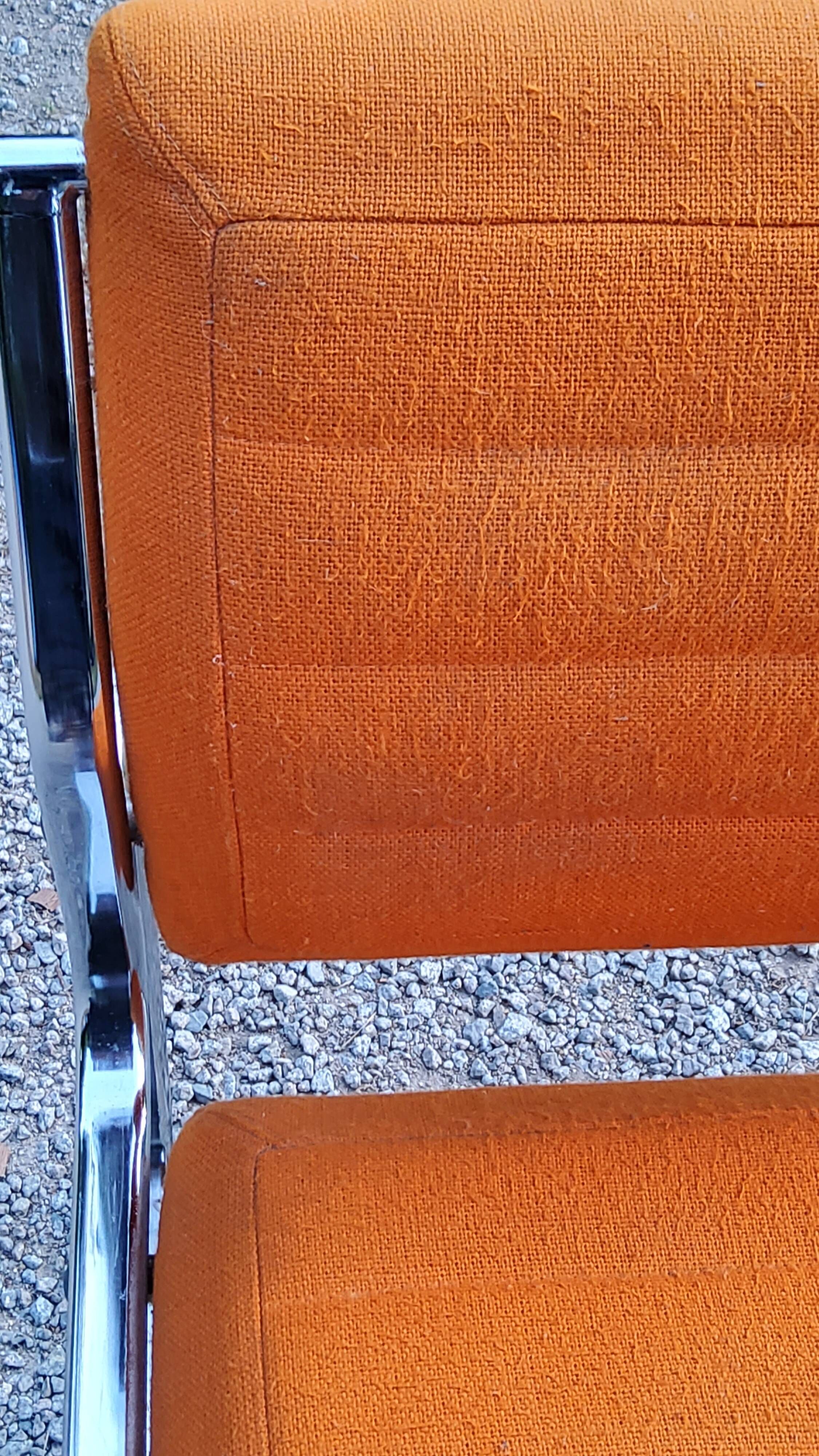 Pair of designer armchairs in orange fabrics and chrome tubes from the 70s