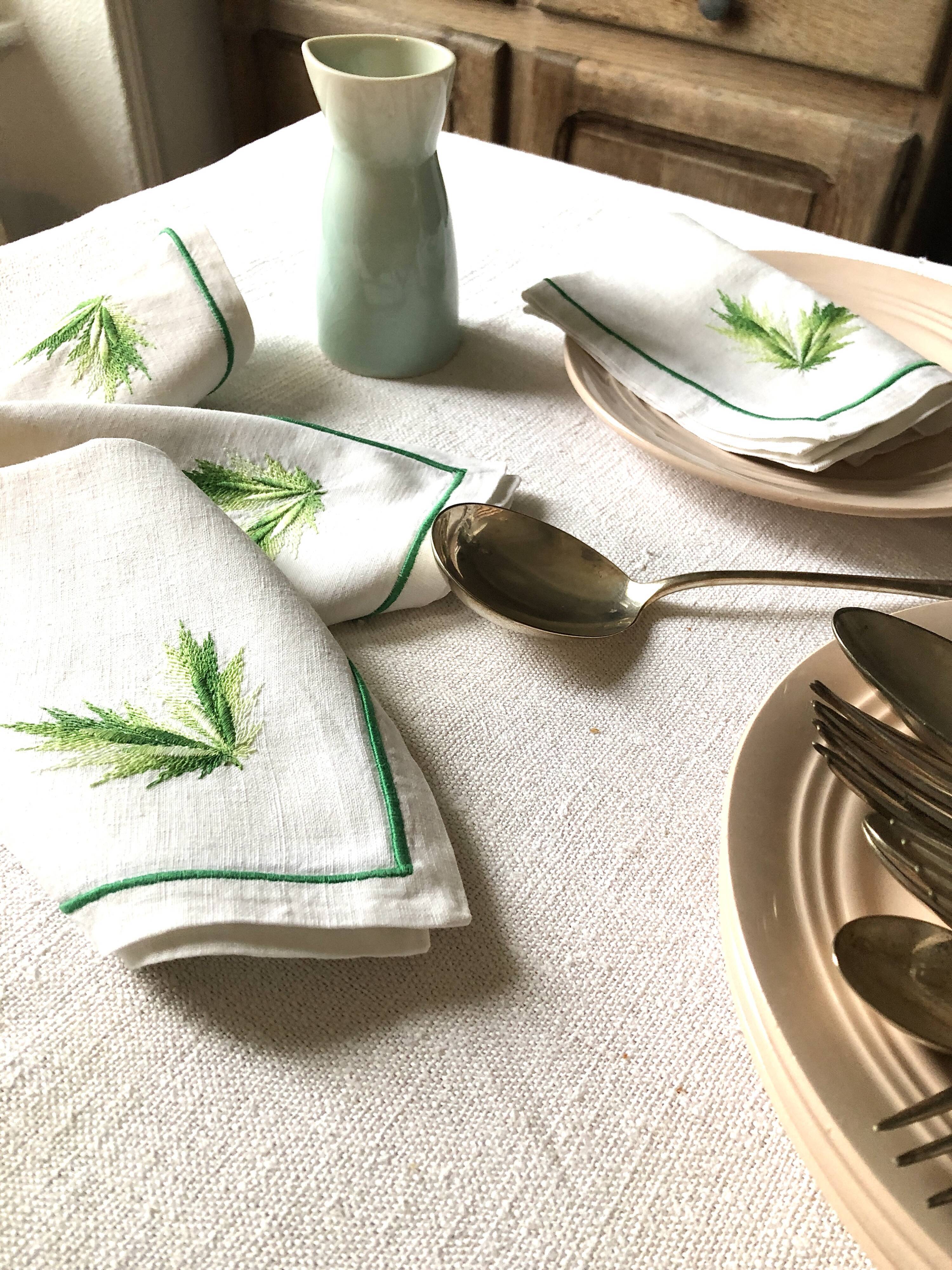 Series of four embroidered linen napkins