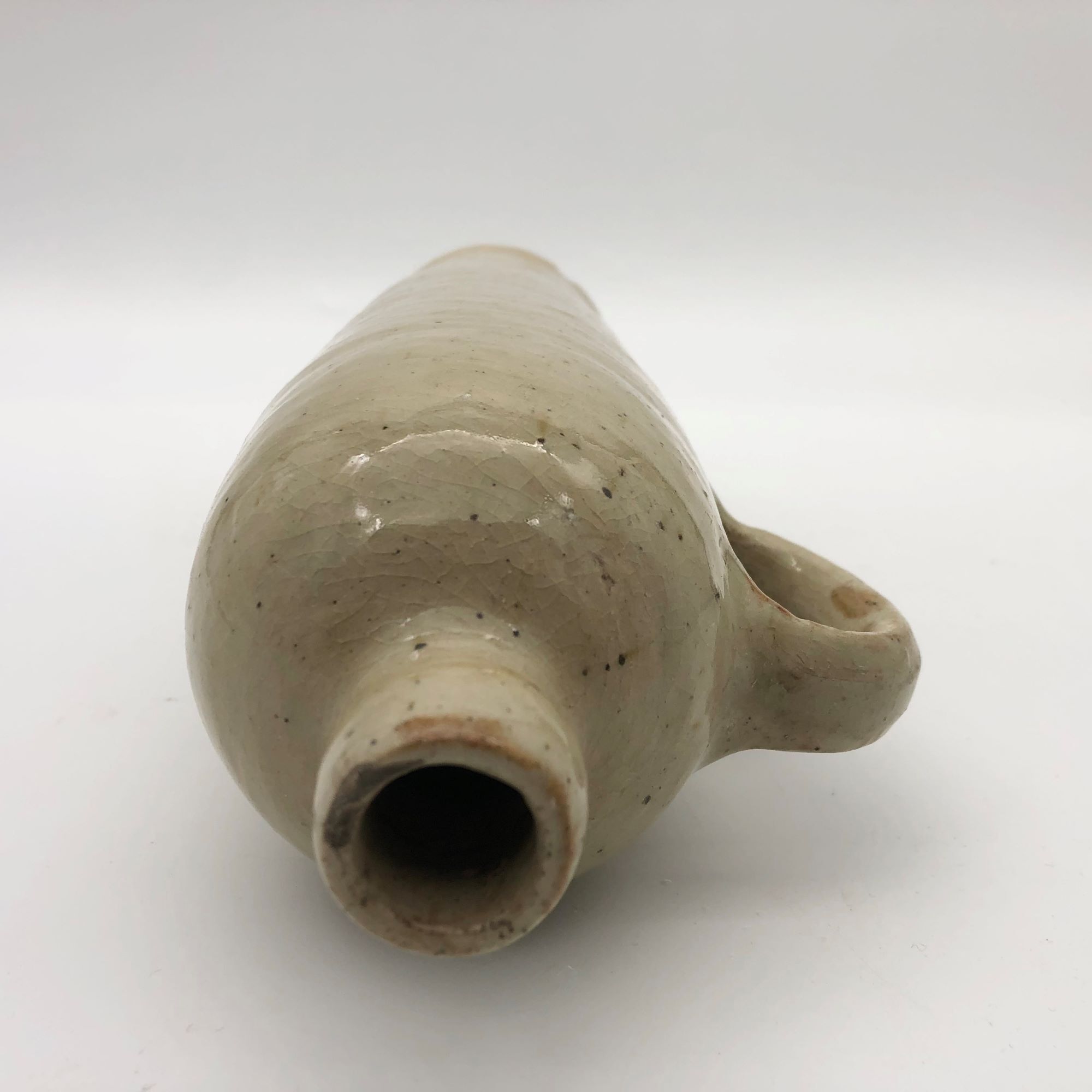 Old hot water bottle in glazed stoneware, beige color