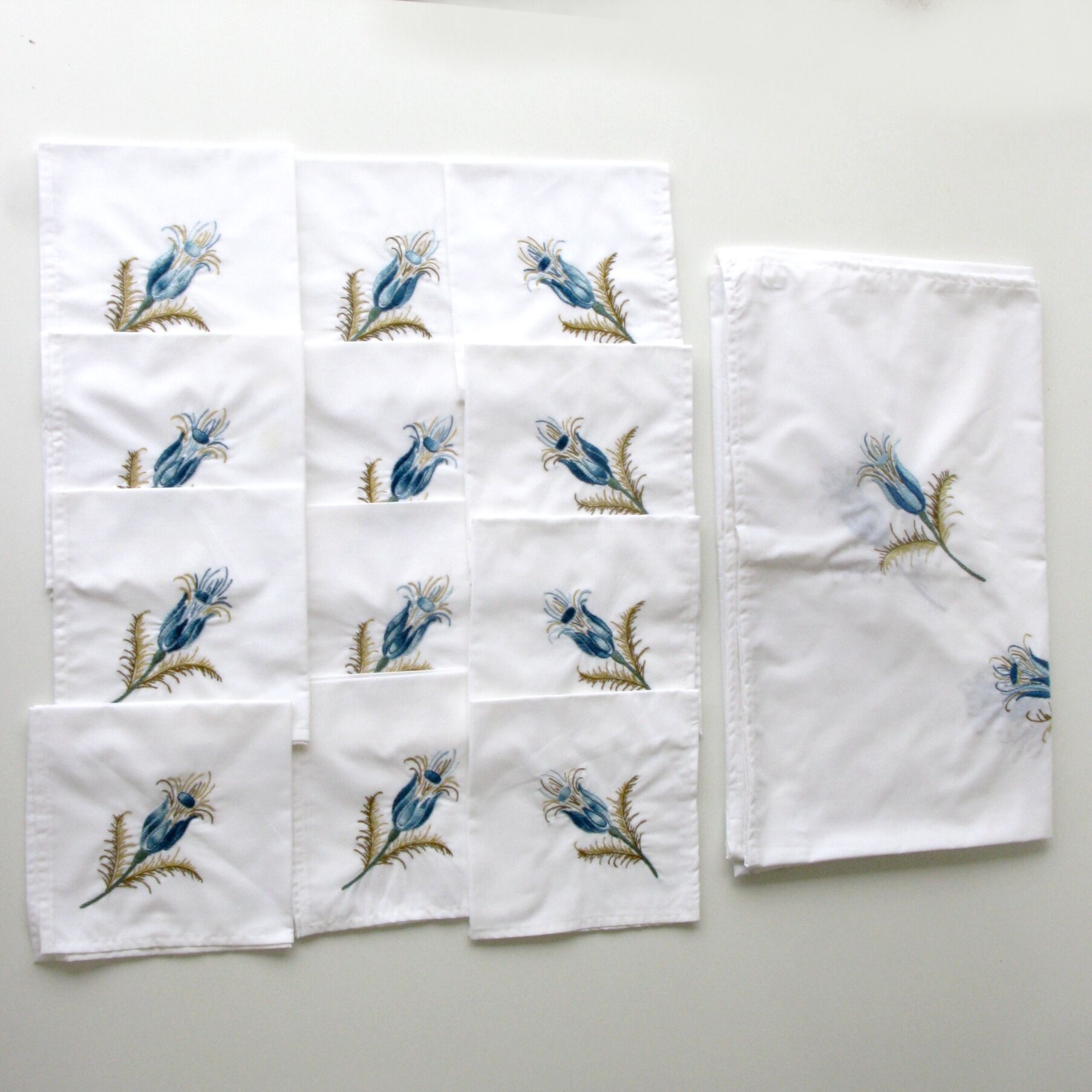 Antique rectangular hand-embroidered tablecloth decorated with thistle and 12 towels