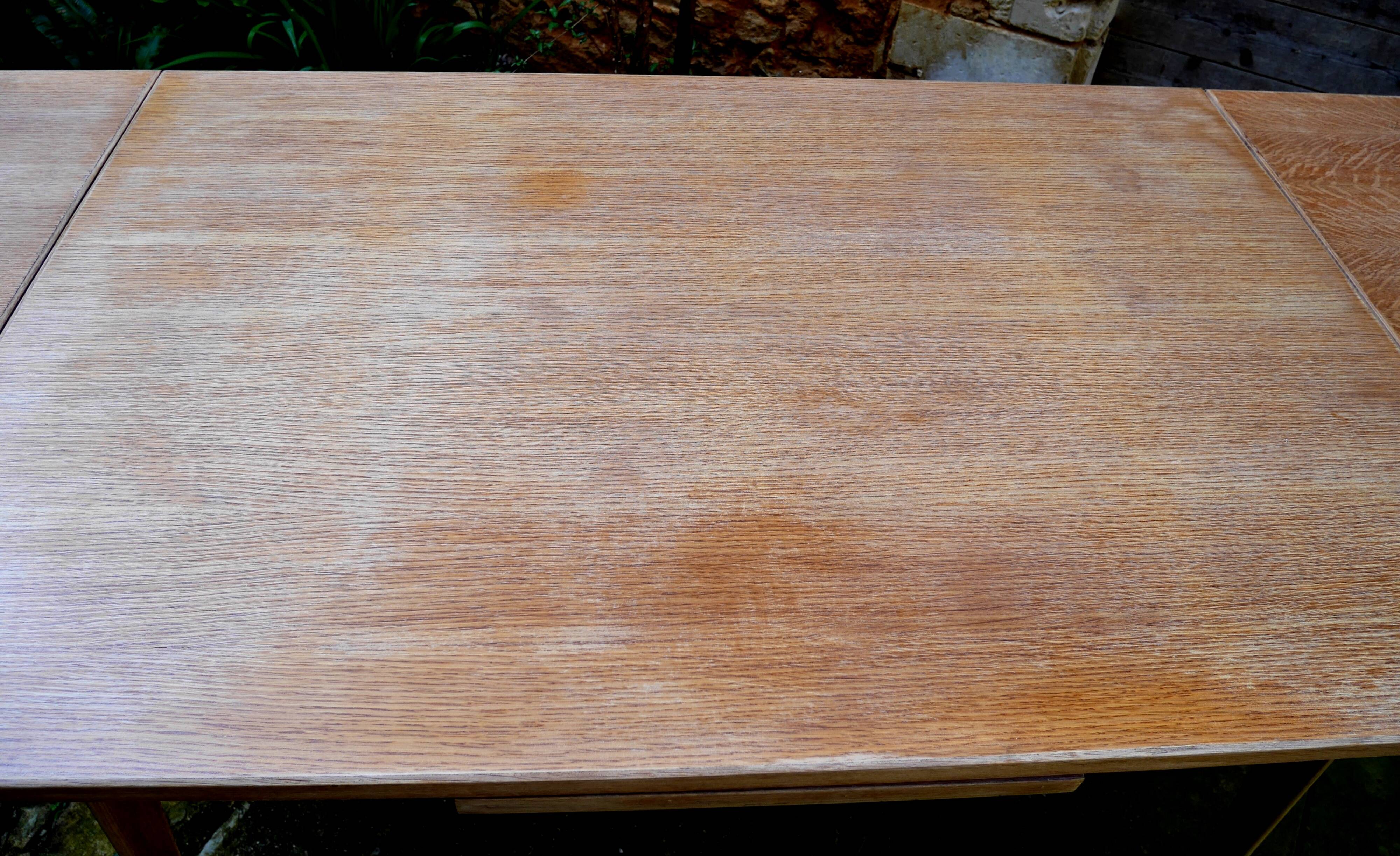 wooden dining table with compass legs and extensions