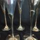 Lot of 12 silver metal flutes on brass stand