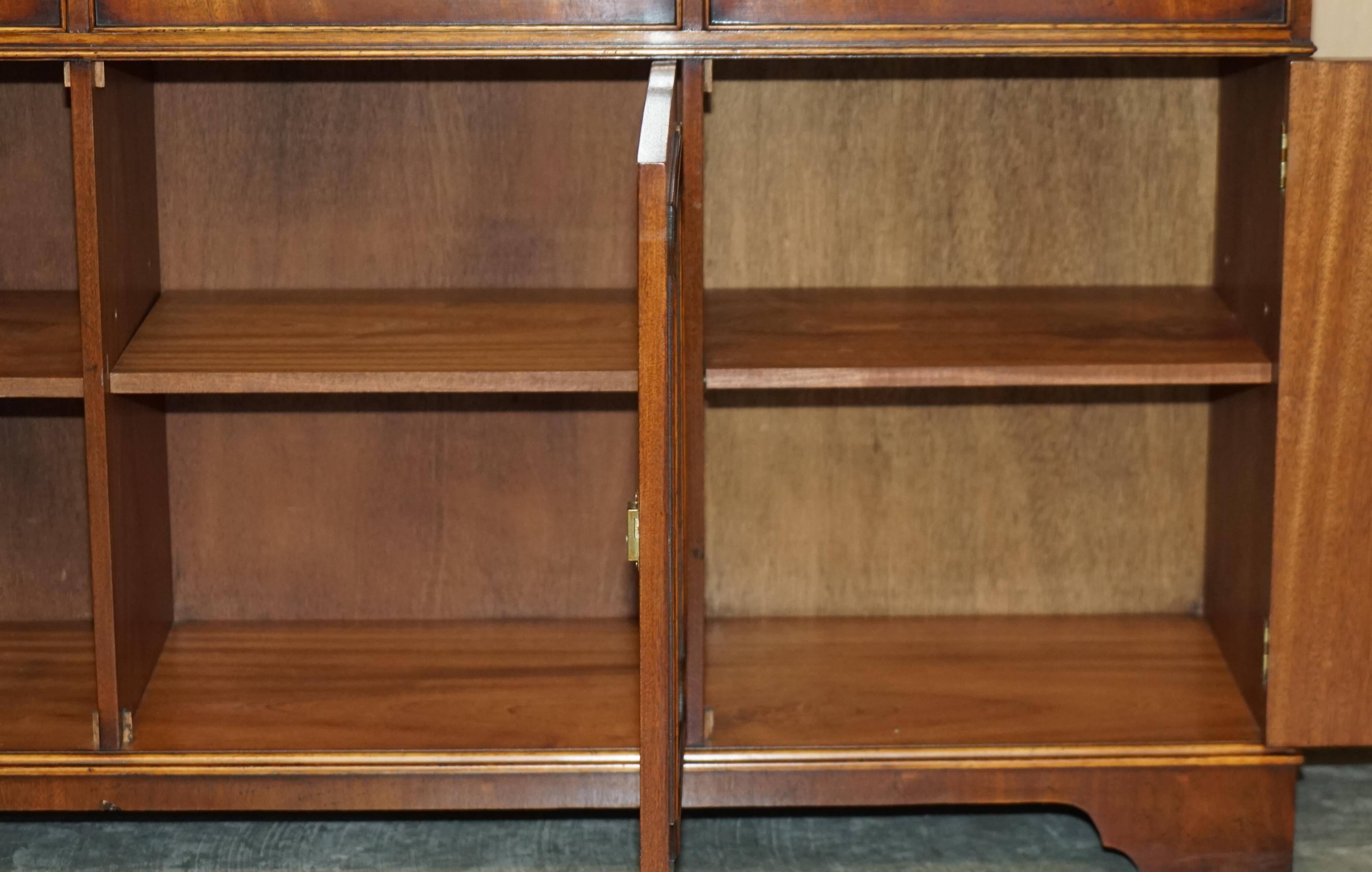 Vintage mahogany buffet with three drawers and shelves.