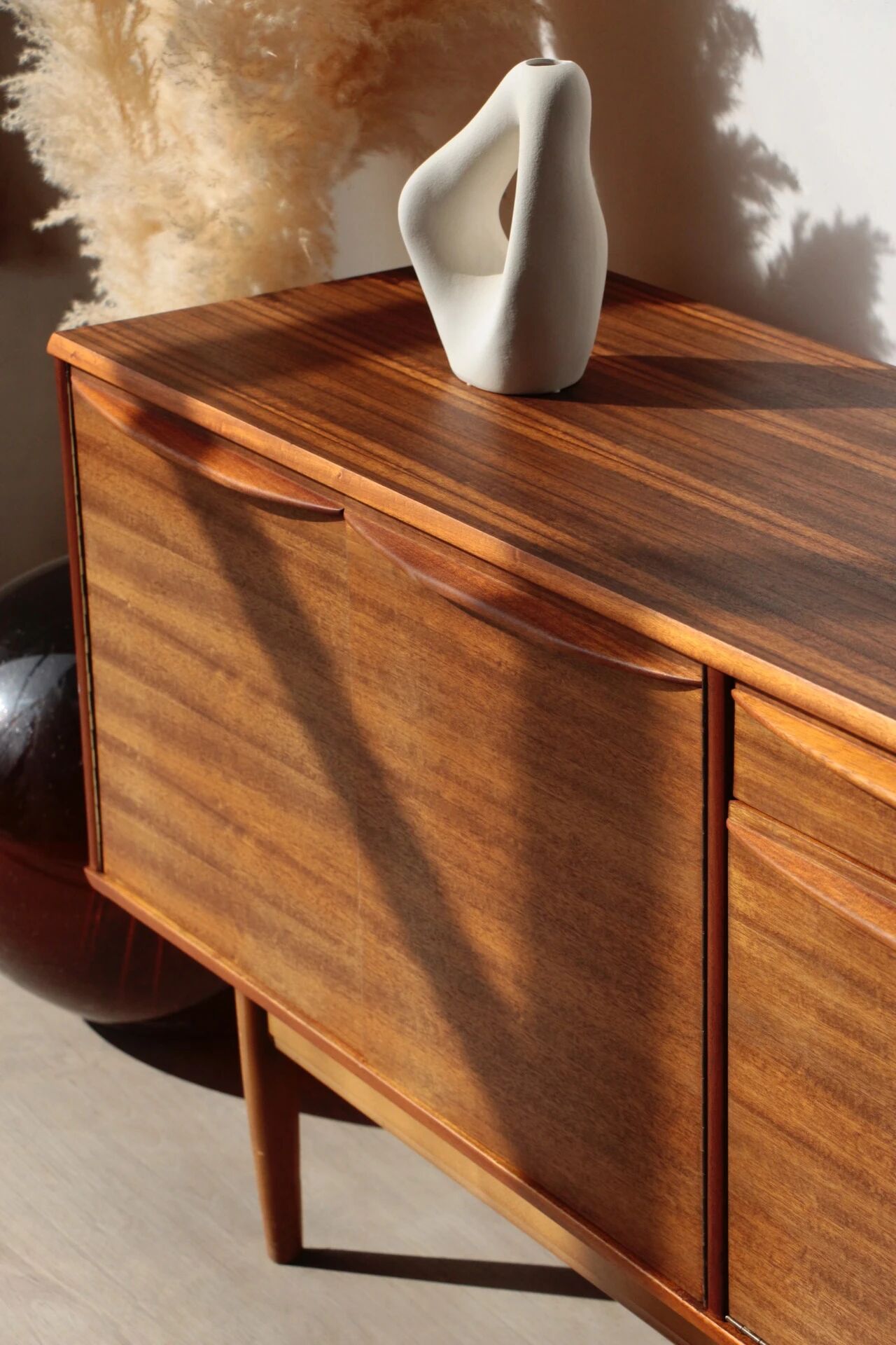 Vintage zebrano and walnut furniture from Morris of Glasgow.