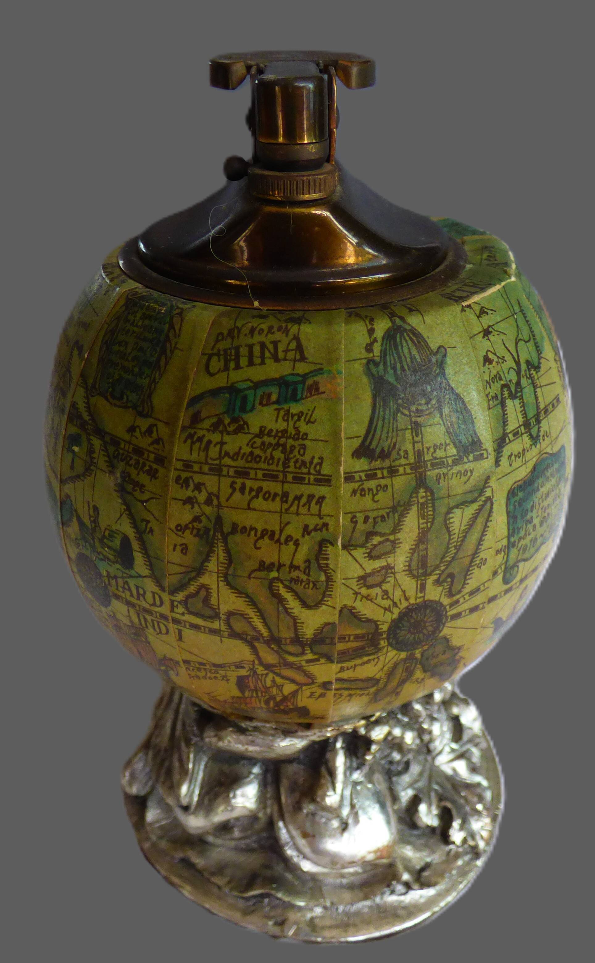 Vintage antique lighter with a globe and silver-plated stand.