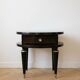Art Deco bedside table in black wood with gold details.