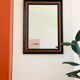 Old wall mirror 72 x 52 cm in black wood and faux mahogany