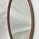 Oval beveled mirror surrounded by light wood dimension: height -74,5cm- width -38,5cm- prof-2cm-